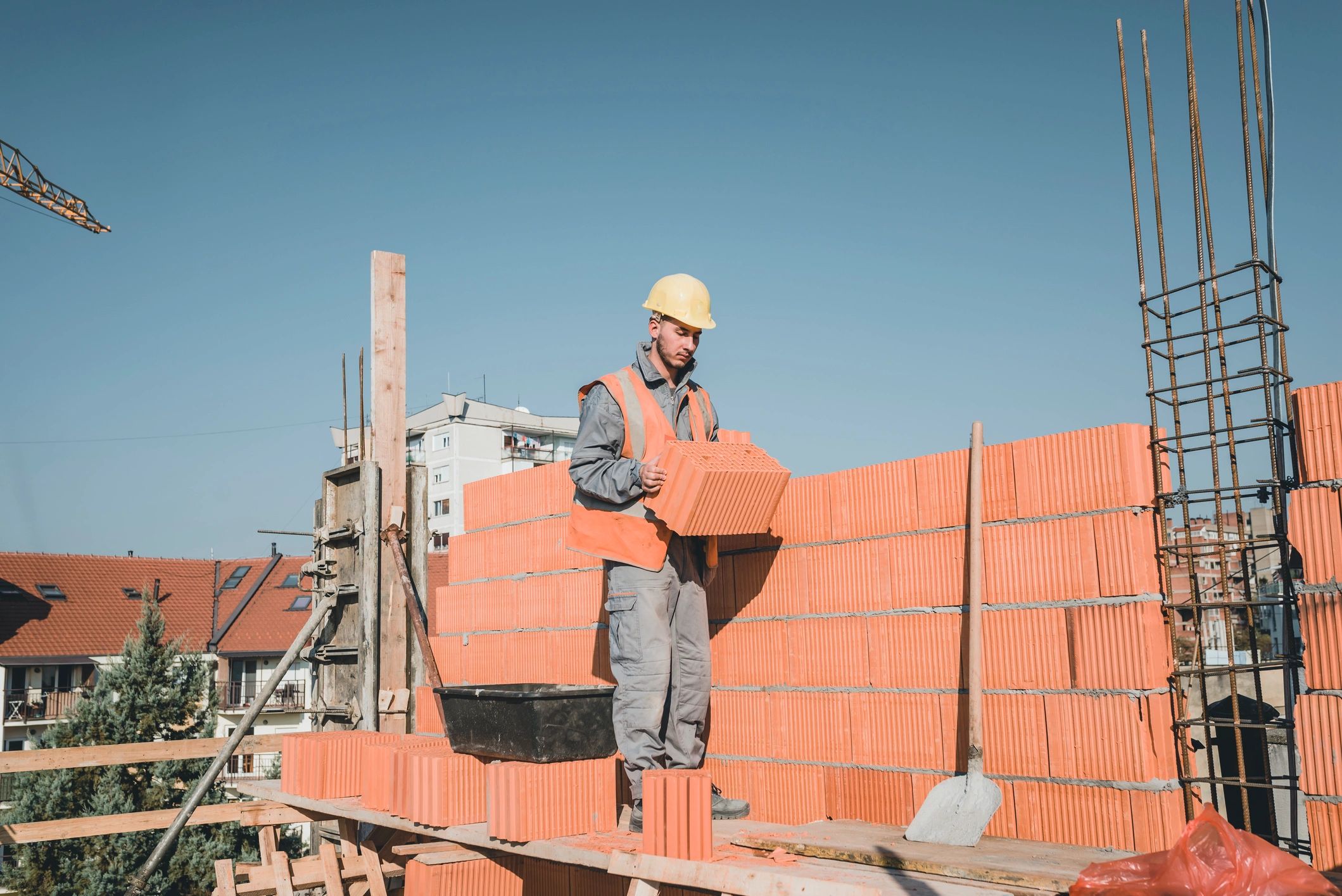 Masonry professional laying bricks on a construction site