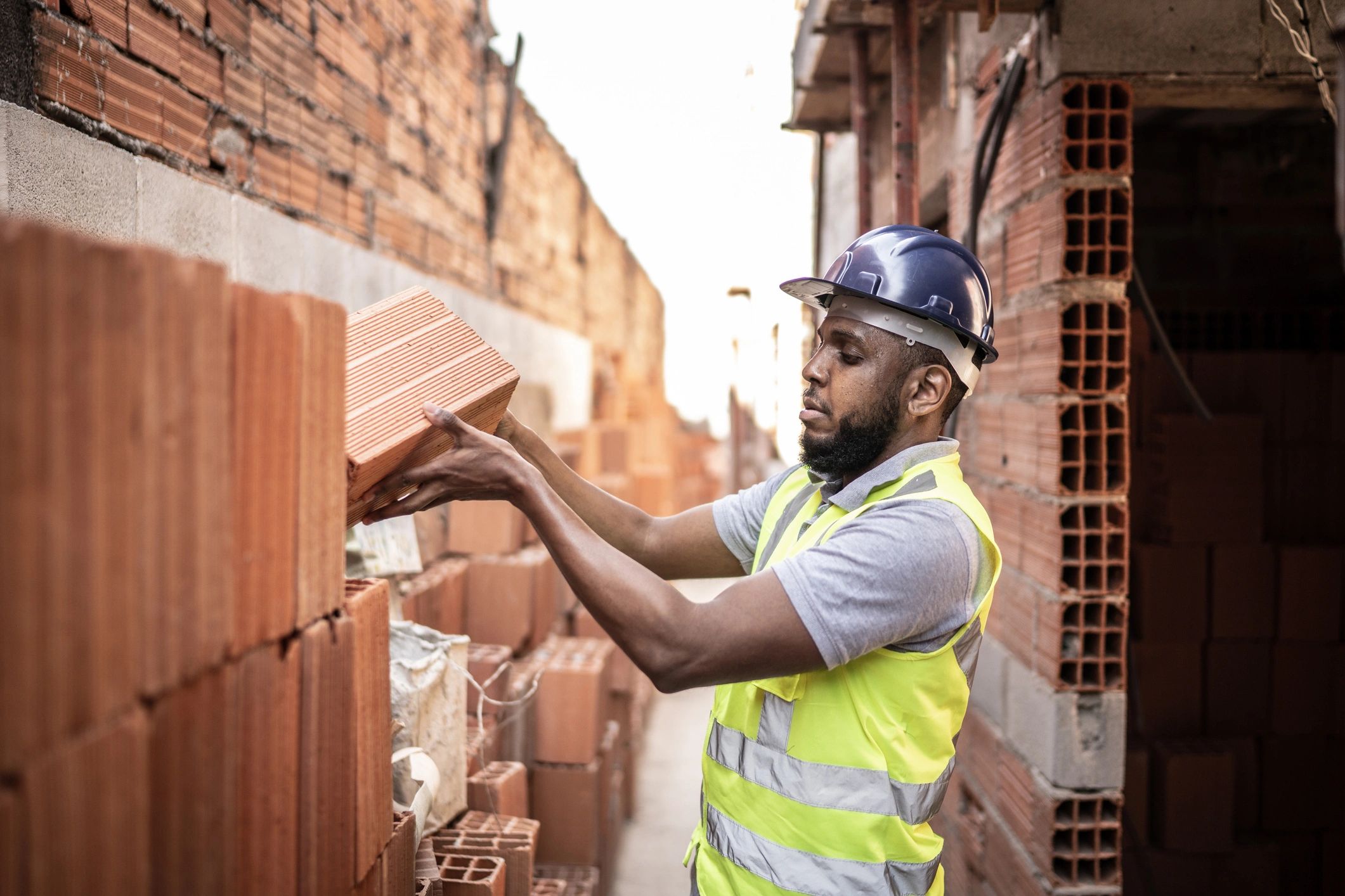 Mason laying brickwork on a residential wall
